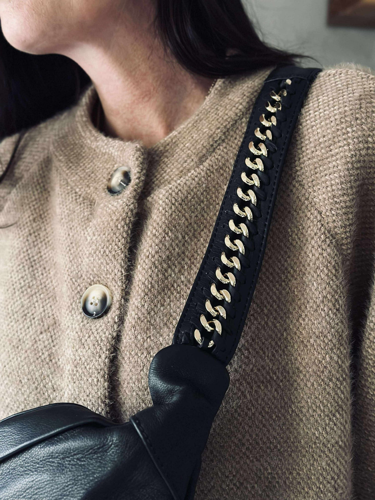 Bumbag met goudkleurige ketting op de schouderriem